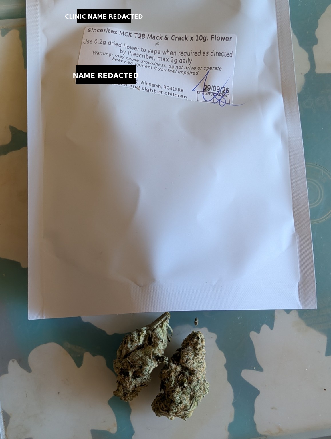 A dispensed medical cannabis bag with the clinic name and personal name blacked out.